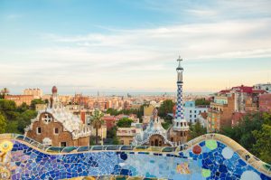 Gaudi's ceramic bench in Parc Guell and skyline of Barcelona, Spain